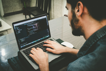 A man coding on a computer.